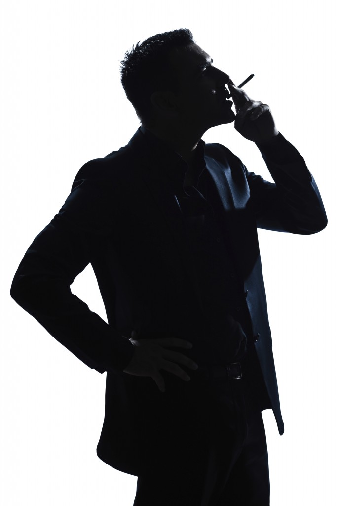 one caucasian man portrait smoking cigarette silhouette in studio isolated white background